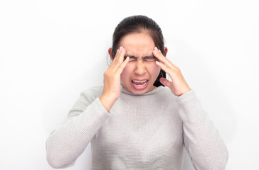 Naklejka premium Portrait of Asian woman sitting at her room, white wall. She have a headache and stressed. Health care concept. Space for text input.