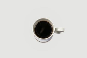 Top view of a cup of coffee, isolated on soft gray background.