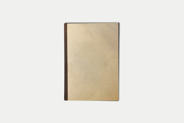 Old brown notebook isolated on soft gray background.