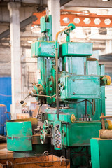 Industrial concept. A green construction machine in the plant