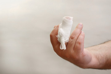 injured finger wrapped with gauze bandage with copy space