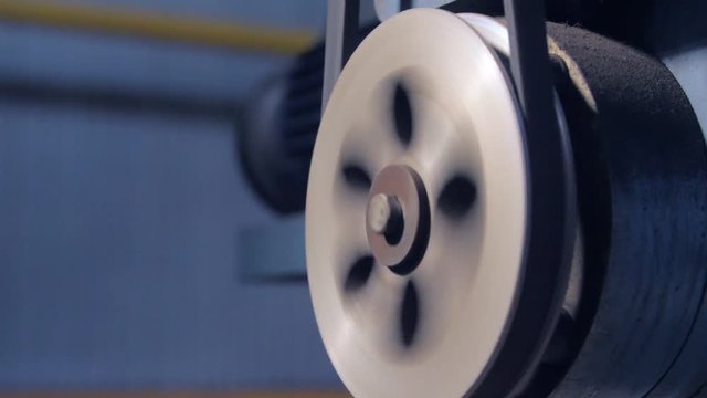 closeup lever with transmission belt turns at compressor