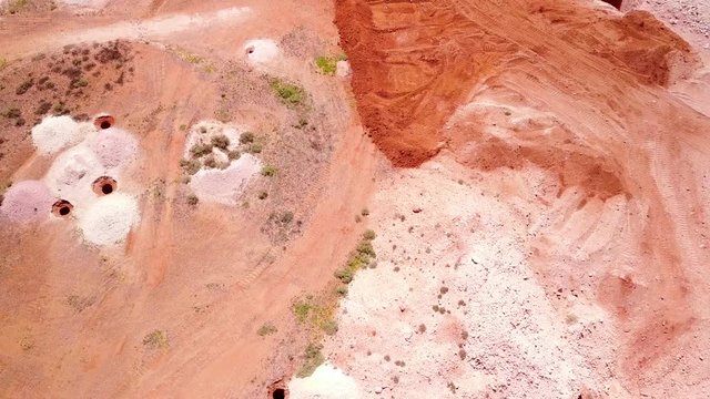 Aerial drone shot of opal mines and mining tailings in the desert outback of Coober Pedy Australia.