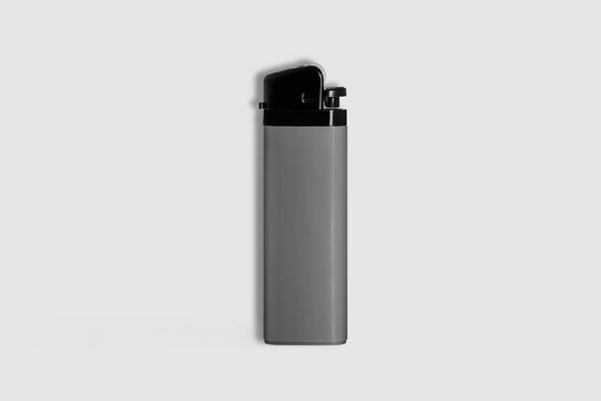 Gray plastic gas lighter. Gas lighter isolated on a soft gray background.Closeup shot, top view
