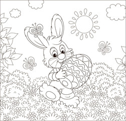 Friendly smiling Easter Bunny with a decorated egg walking among flowers on sunny spring day, black and white vector illustration in a cartoon style for a coloring book