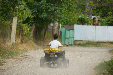 little boy on a quad. the child rides a quad bike © Otar