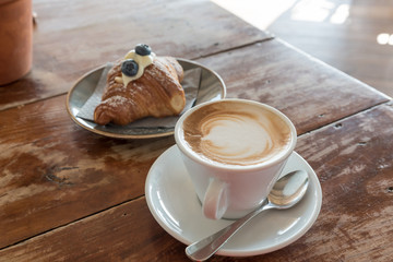Croissant and cappuccino for breakfast