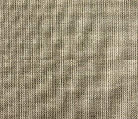The textured beige natural fabric . 