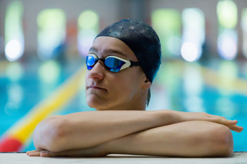 Portrait of athletic teenage boy at the sports pool.
