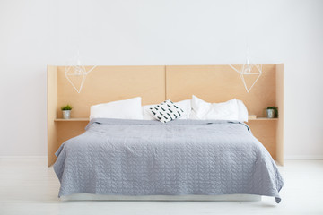 A room in light loft stile with brick wall and light furniture. Comfortable bedroom. A combination...
