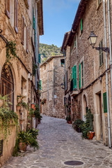 Fototapeta na wymiar Empty narrow street in the old Valldemossa village - Mallorca, Spain
