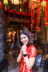 Portrait of beautiful asian girl in red chinese drees up in China town