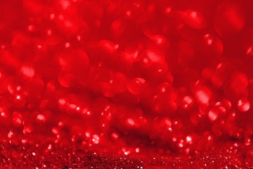 red glossy metallic sand made of glitters - festival concept with bokeh texture - fantastic abstract photo background