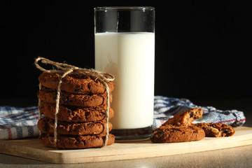 A glass with milk and chocolate cookies