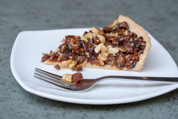 Vegan cake with dates and walnuts, baked homemade. Close up