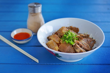 Still life photography of food : Stewed beef with gravy sauce style chinese food on top noodles. Selective and focus. Shooting in studio, Clean food good taste idea concept.