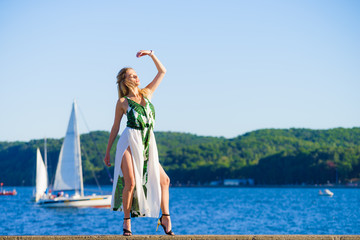 Woman in summer long dress against sea
