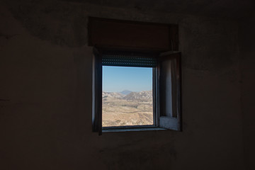 Fototapeta na wymiar Looking out a Window in an Abandoned Ruin in Southern Italy