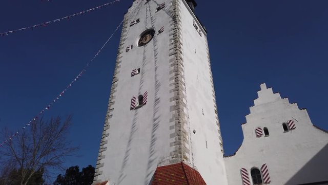 Pfullendorf, Germany. The old tower Oberes part of the ancient medieval fortifications of the city. Small fabric flags waving during the carnival