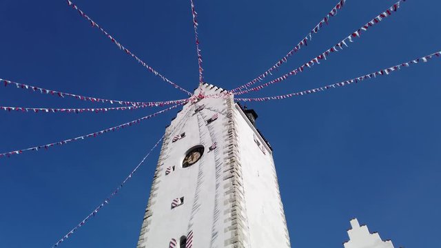 Pfullendorf, Germany. The old tower Oberes part of the ancient medieval fortifications of the city. Small fabric flags waving during the carnival