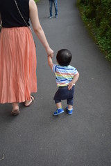 Infant walking with mother behind you 1 year 3 months
