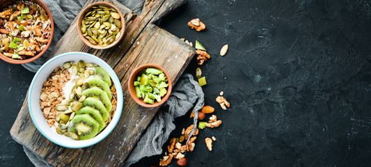 Oatmeal with kiwi and pumpkin seeds. Top view. Free space for your text.