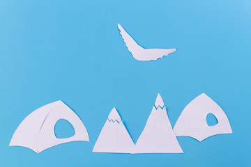 The tent stands on the background of high mountains.