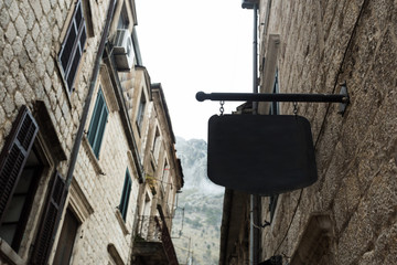 Fototapeta na wymiar shape traditional bar signage mockup in old city center
