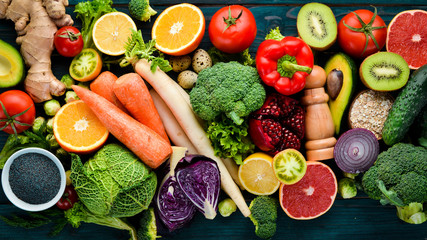Healthy organic food on a blue wooden background. Vegetables and fruits. Top view. Free copy space.