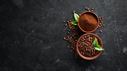 Ground coffee and coffee beans. Assortment of coffee varieties on a black background. Top view. Free space for your text.
