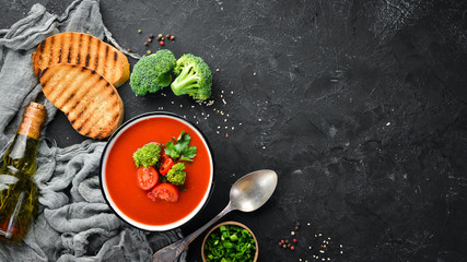 Tomato soup with vegetables and parsley. Mexican soup in a bowl. Top view.