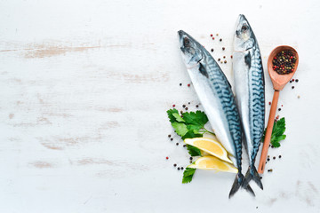 Mackerel on a white wooden background. Raw fish Top view. Free copy space.