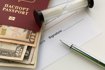 Signing a document. Passport of Russian Federation with US dollars banknotes, sand glass and pen. Topics of rent a car, car sharing, insurance compensation. Selective focus