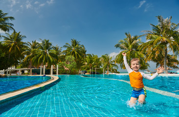Toddler boy in resort swimming pool