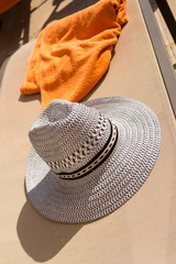 Sun Hat and Towel on Empty Sun Bed