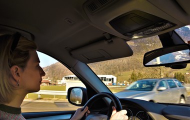 young woman driving a car in the mountains