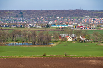 Fototapeta na wymiar Landscape view of a farm on the fields at a city
