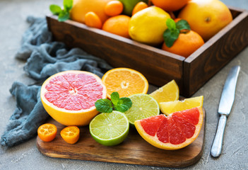 box with citrus fresh fruits on a concrete background
