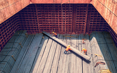 steel billets stacked to loading from a ship in port - the raw material for the manufacture of...