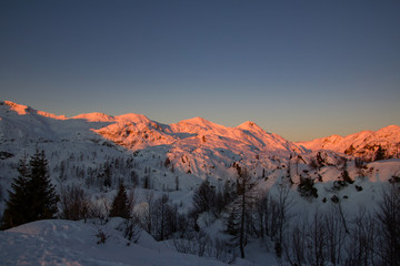 Sunset in snowcaped mountains. Mountains are orange color. Slovenia, Juliana Alps, Komna. The paradise for ski touring.