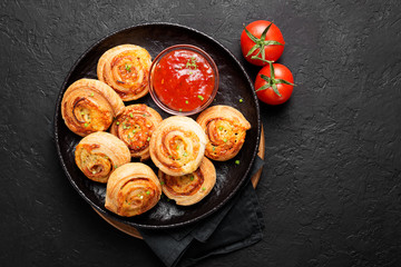 Rolls of puff pastry with bacon and cheese .
