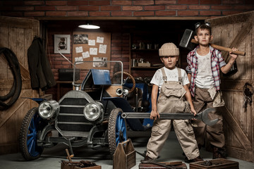 Plakat Boys-mechanic with tools in the car in the garage