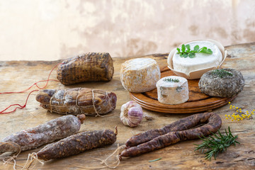 Corsican wild pork delicatessen, and cheese specialities, made in Corsica France on wooden background