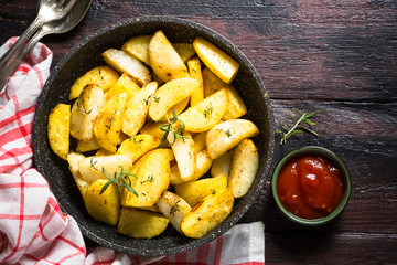 Baked potato with herbs top view.