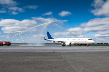 Water salute by fire truck at the airport for first visit passenger aircraft