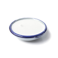 Coconut milk in a ceramic cup isolated on a white background.