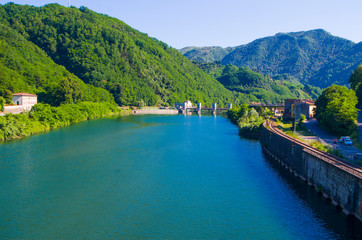 dam on the azure lake in the middle of the green mountains