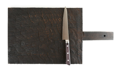 Utility knife on wooden board, isolated