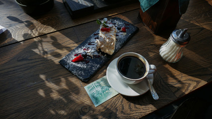 Kuwaiti banknotes lying under a cup of coffee 