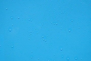 Obraz premium water drop on blue plastic texture
